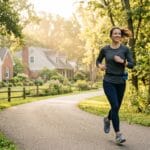 Mom doing zone 2 running on a quiet morning path