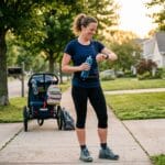 Mom runner checking smartwatch after a morning run without overtraining